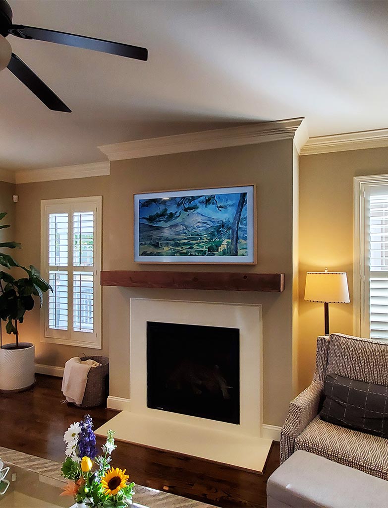 Beautiful Samsung Frame TV with a custom frame that we installed over a fireplace.