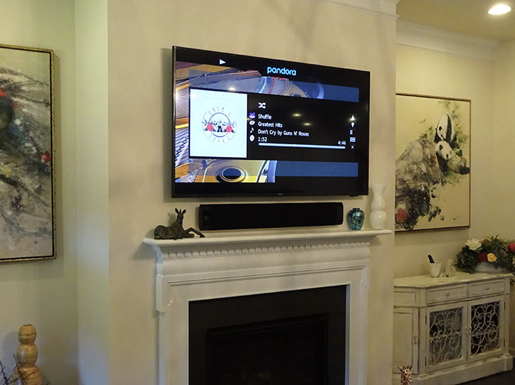 TV and soundbar that we installed over a fireplace.